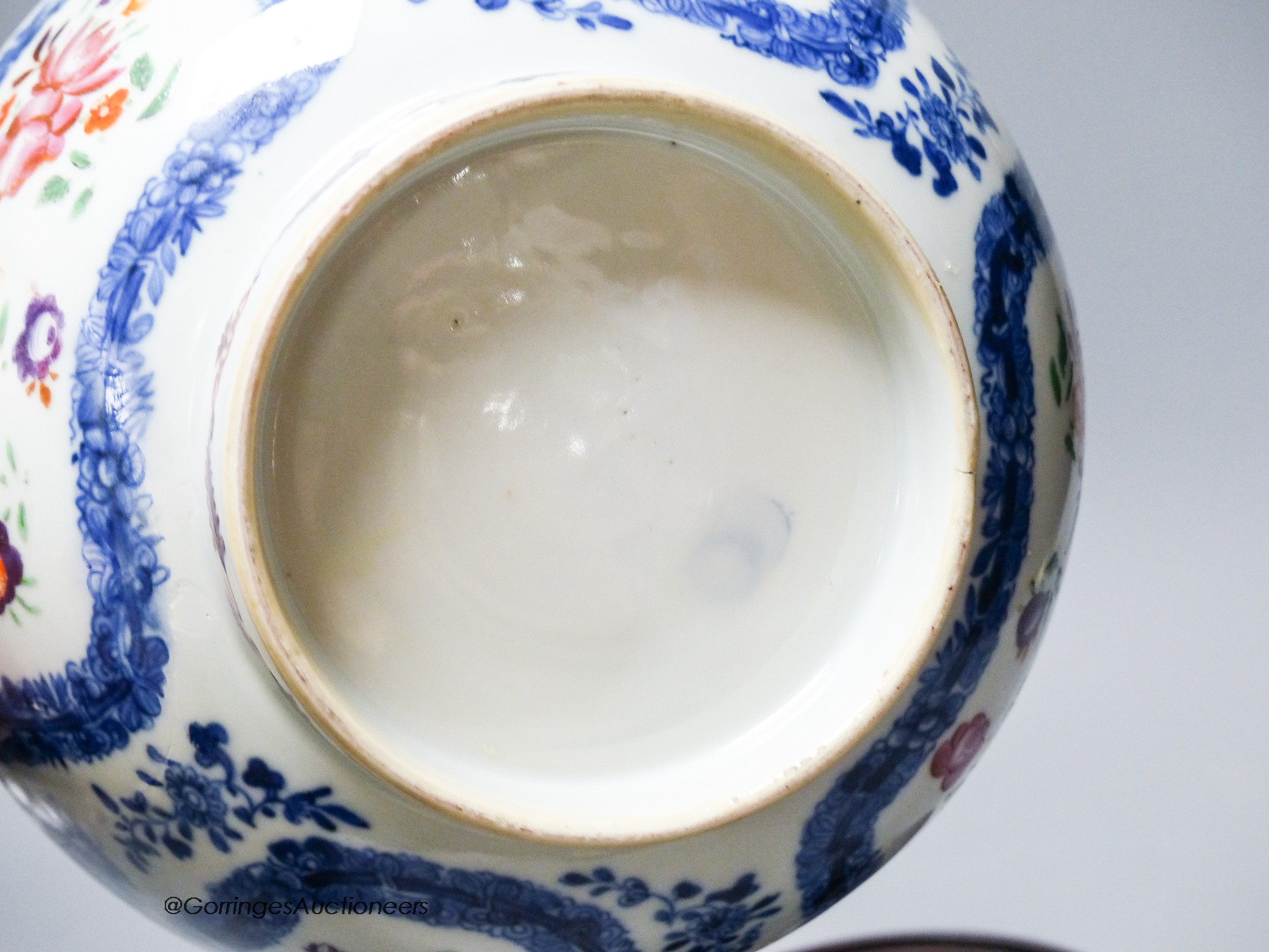 A 18th century Chinese export porcelain footed punch bowl on hardwood stand, diameter 20cm, restored